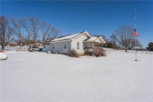 snow covered property featuring covered porch