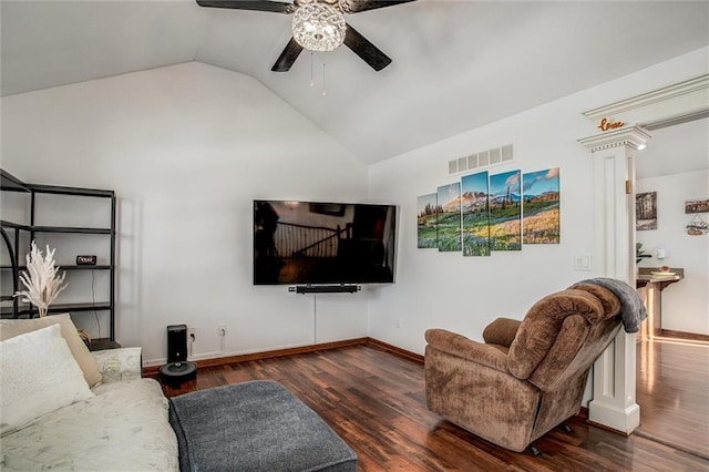 living room featuring ceiling fan, dark hardwood / wood-style floors, vaulted ceiling, and ornate columns