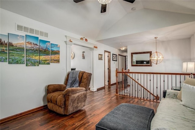 living room featuring lofted ceiling, ceiling fan with notable chandelier, dark hardwood / wood-style floors, and ornate columns