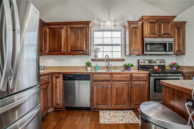 kitchen featuring lofted ceiling, sink, dark hardwood / wood-style floors, and appliances with stainless steel finishes