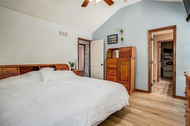 bedroom featuring lofted ceiling, light hardwood / wood-style floors, and ceiling fan