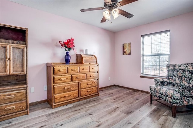 living area featuring ceiling fan and light hardwood / wood-style flooring