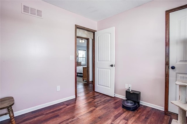 bedroom with dark hardwood / wood-style flooring