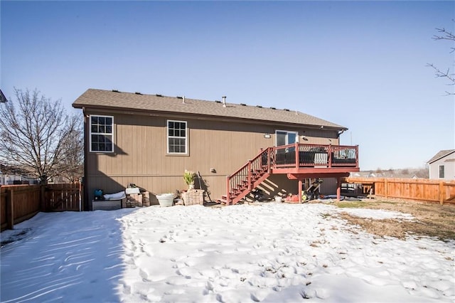 snow covered property with a deck