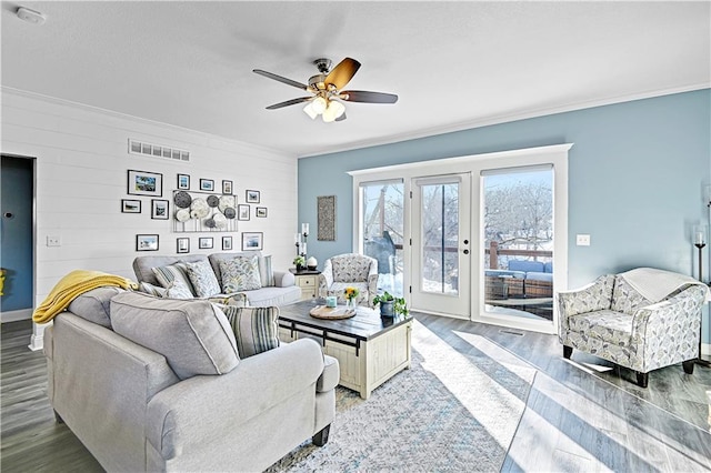 living room featuring hardwood / wood-style flooring, ornamental molding, and ceiling fan