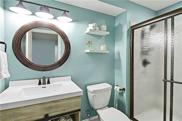 bathroom featuring toilet, walk in shower, and vanity