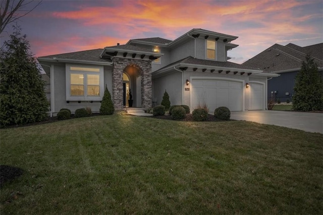 view of front facade with a garage and a yard