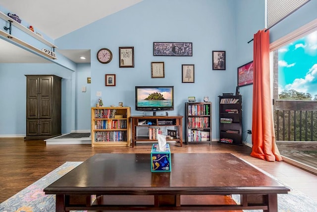 home office featuring high vaulted ceiling and dark hardwood / wood-style flooring