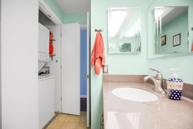 bathroom featuring stacked washer and dryer, tile patterned floors, and vanity