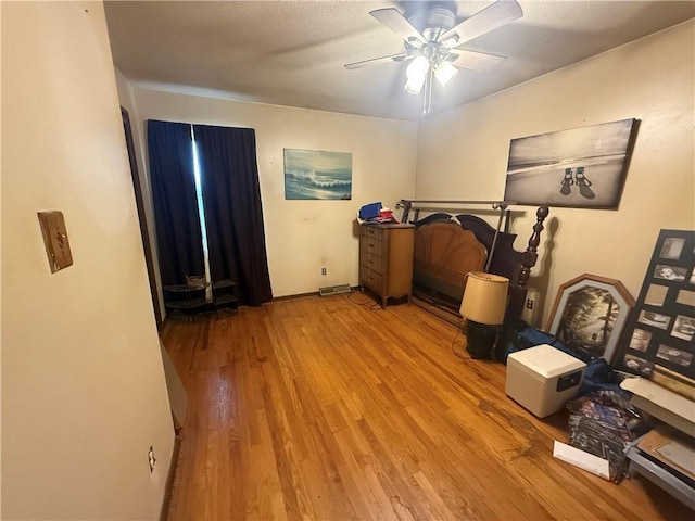 bedroom with ceiling fan and light wood-type flooring