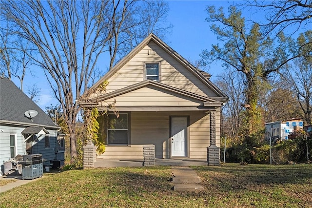 bungalow-style house with a porch and a front lawn