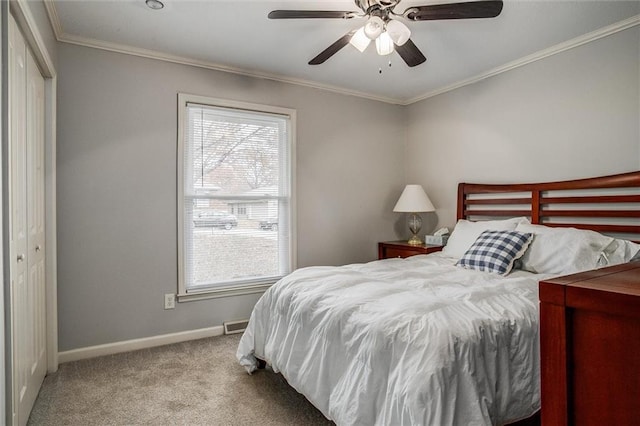 bedroom featuring multiple windows, carpet floors, baseboards, and ornamental molding