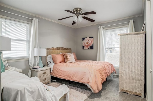 bedroom with a ceiling fan, ornamental molding, and carpet flooring