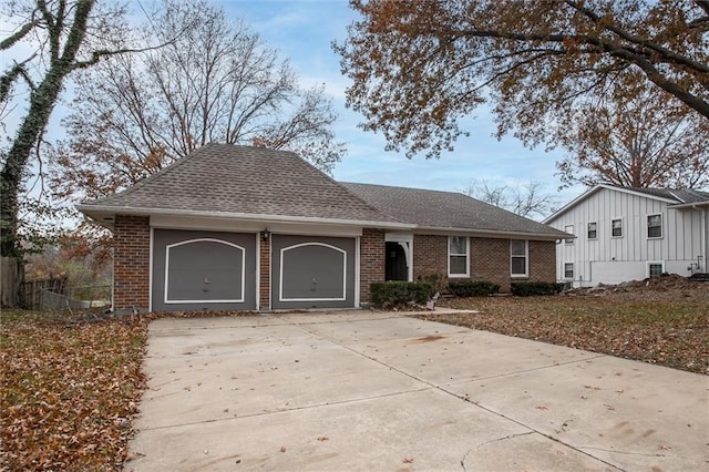 single story home featuring brick siding, an attached garage, concrete driveway, and a shingled roof