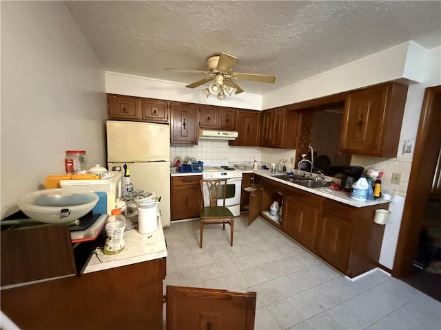 kitchen featuring ceiling fan, white appliances, decorative backsplash, and a textured ceiling