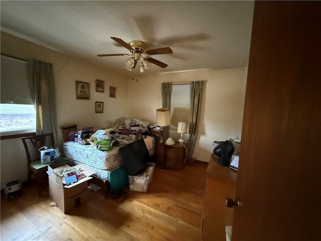 bedroom with wood-type flooring and ceiling fan