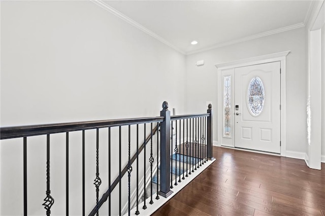 foyer entrance with dark hardwood / wood-style floors and ornamental molding