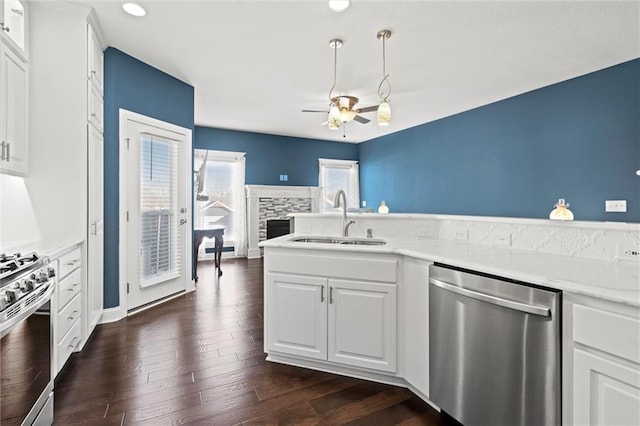 kitchen with ceiling fan, appliances with stainless steel finishes, white cabinetry, and sink