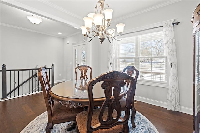 dining room with ornamental molding, a healthy amount of sunlight, dark hardwood / wood-style floors, and a notable chandelier