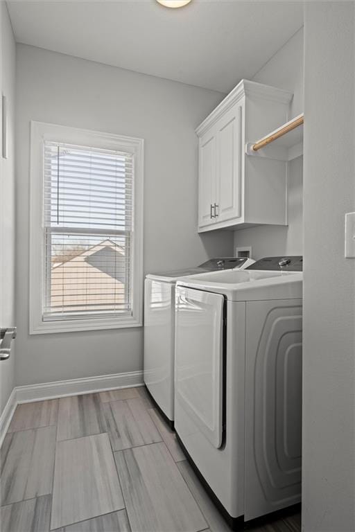 laundry room featuring cabinets and separate washer and dryer