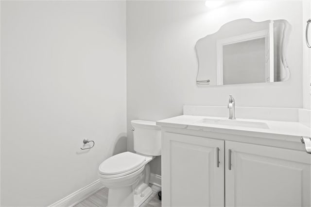 bathroom with toilet and vanity