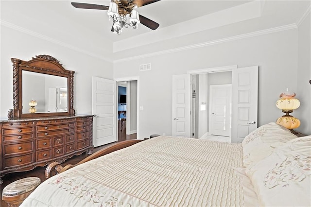 bedroom featuring a raised ceiling, ceiling fan, and crown molding