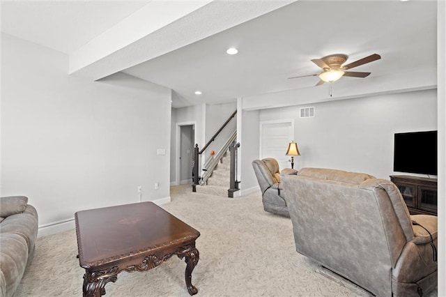 living room featuring ceiling fan and light colored carpet