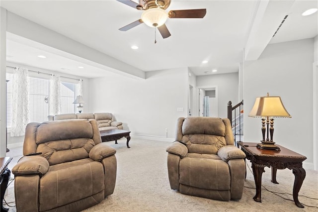 living room featuring ceiling fan and light colored carpet