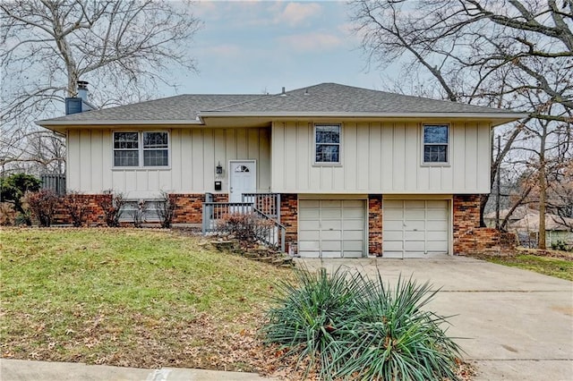 raised ranch featuring a front yard and a garage