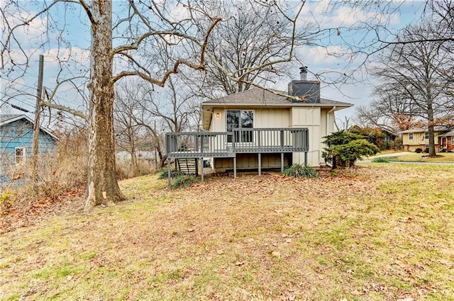 rear view of property with a lawn and a wooden deck