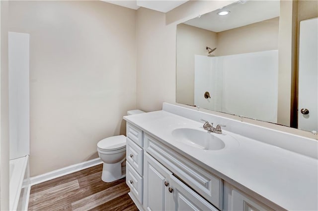 full bathroom featuring toilet, wood-type flooring, vanity, and bathing tub / shower combination