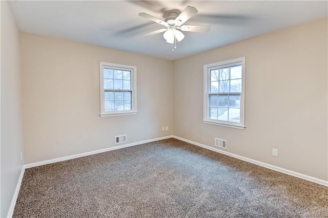 spare room featuring ceiling fan and carpet flooring