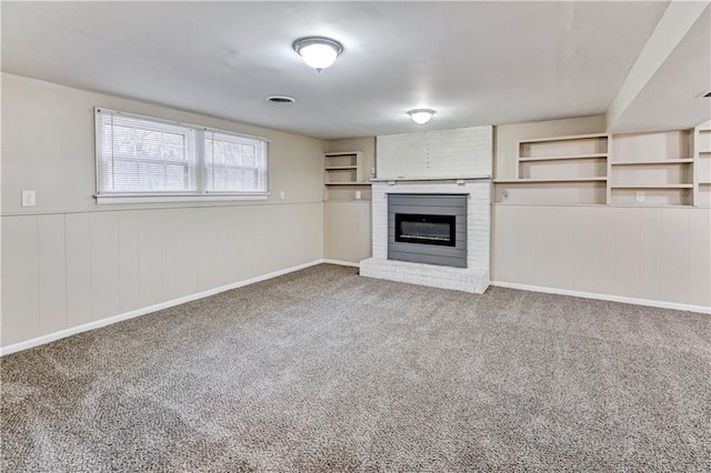 unfurnished living room featuring a fireplace and carpet flooring