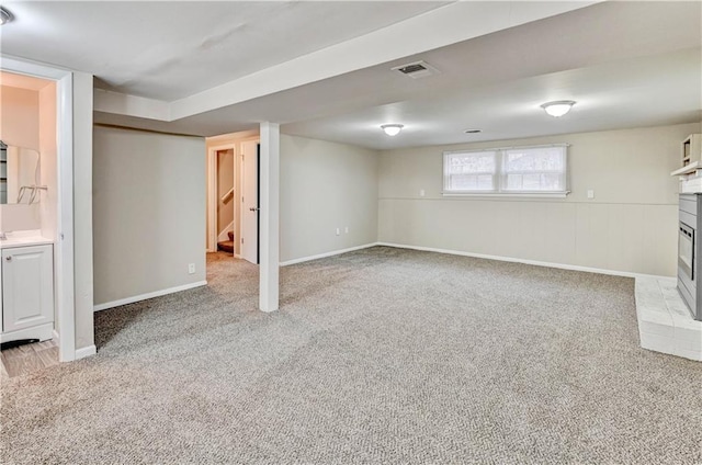 basement featuring light carpet