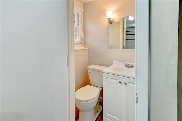 bathroom featuring toilet and vanity