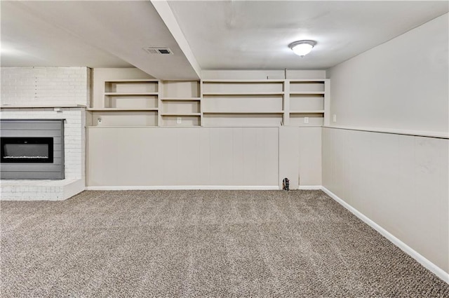 unfurnished living room featuring a fireplace and carpet