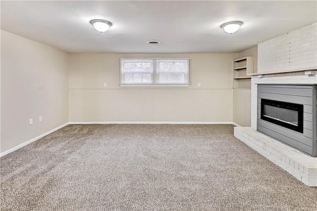 unfurnished living room with a brick fireplace and carpet floors