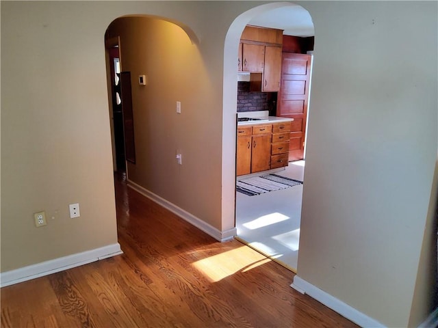 corridor with hardwood / wood-style floors