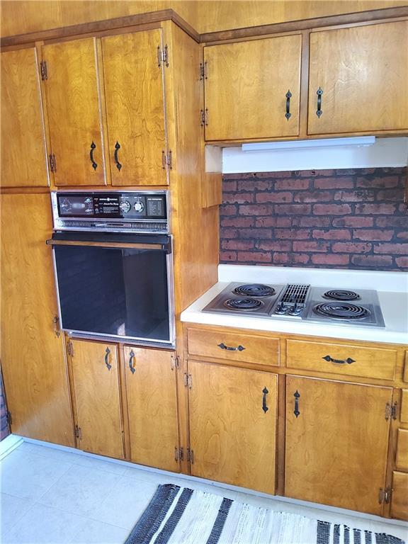 kitchen with black oven and cooktop