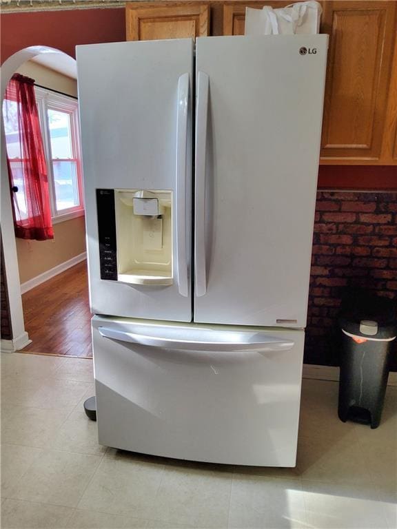 interior space featuring white fridge with ice dispenser