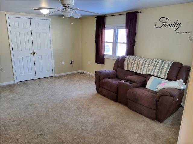 carpeted living room featuring ceiling fan