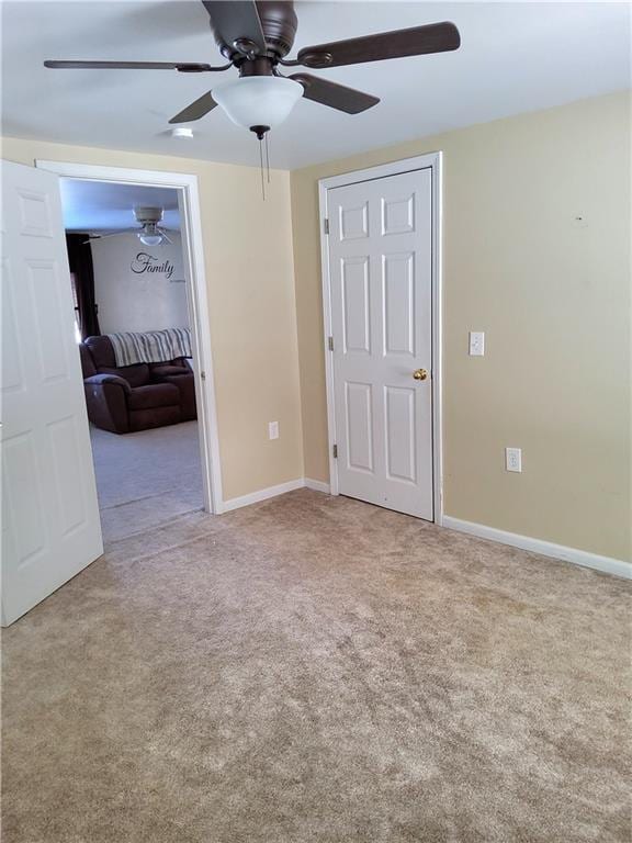 unfurnished bedroom featuring ceiling fan and light carpet