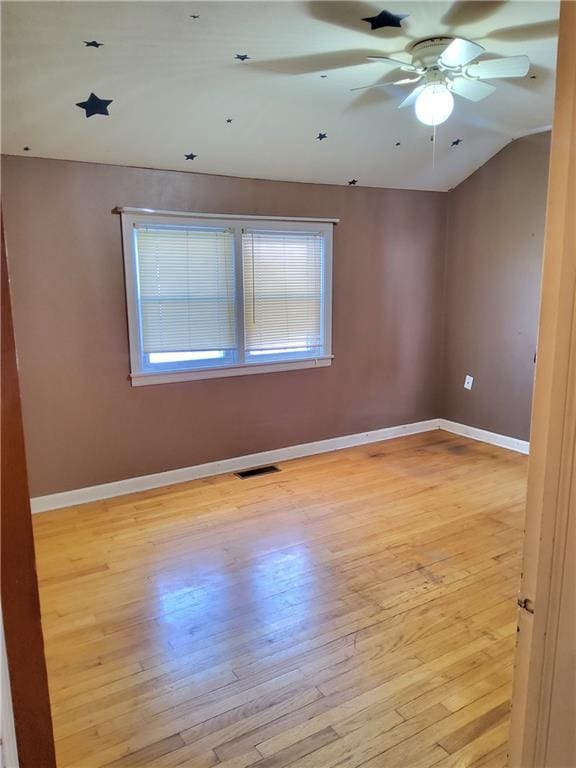 unfurnished room featuring light wood-type flooring, ceiling fan, and vaulted ceiling