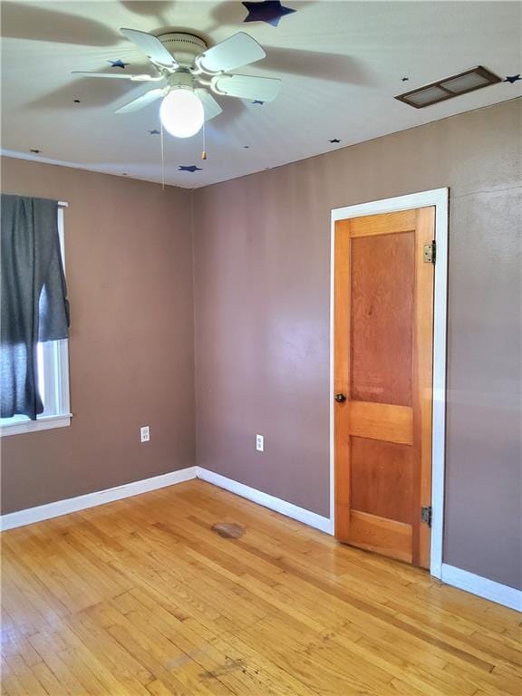 spare room featuring ceiling fan and light hardwood / wood-style floors