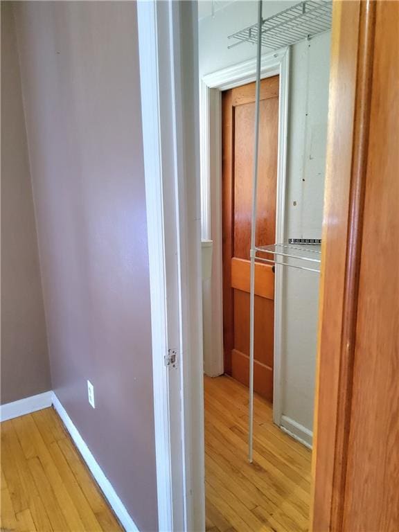 corridor with light hardwood / wood-style flooring