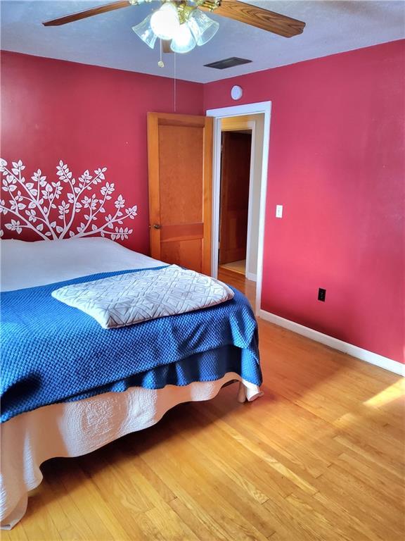 bedroom featuring wood-type flooring and ceiling fan