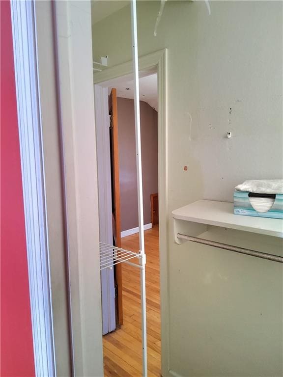 hallway with light hardwood / wood-style flooring