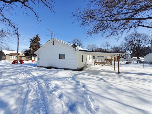 snow covered rear of property with a porch