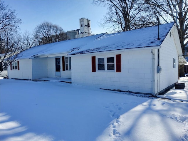 snow covered property featuring central AC