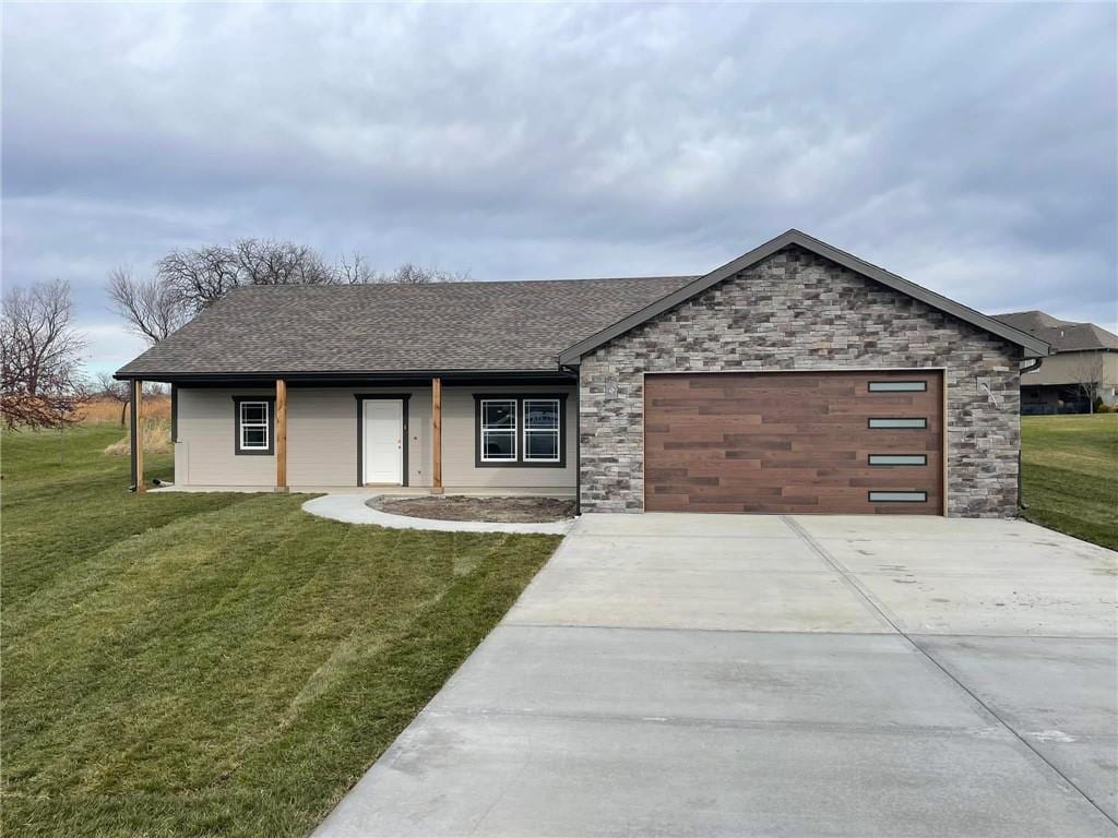 view of front of property featuring a front lawn and a garage